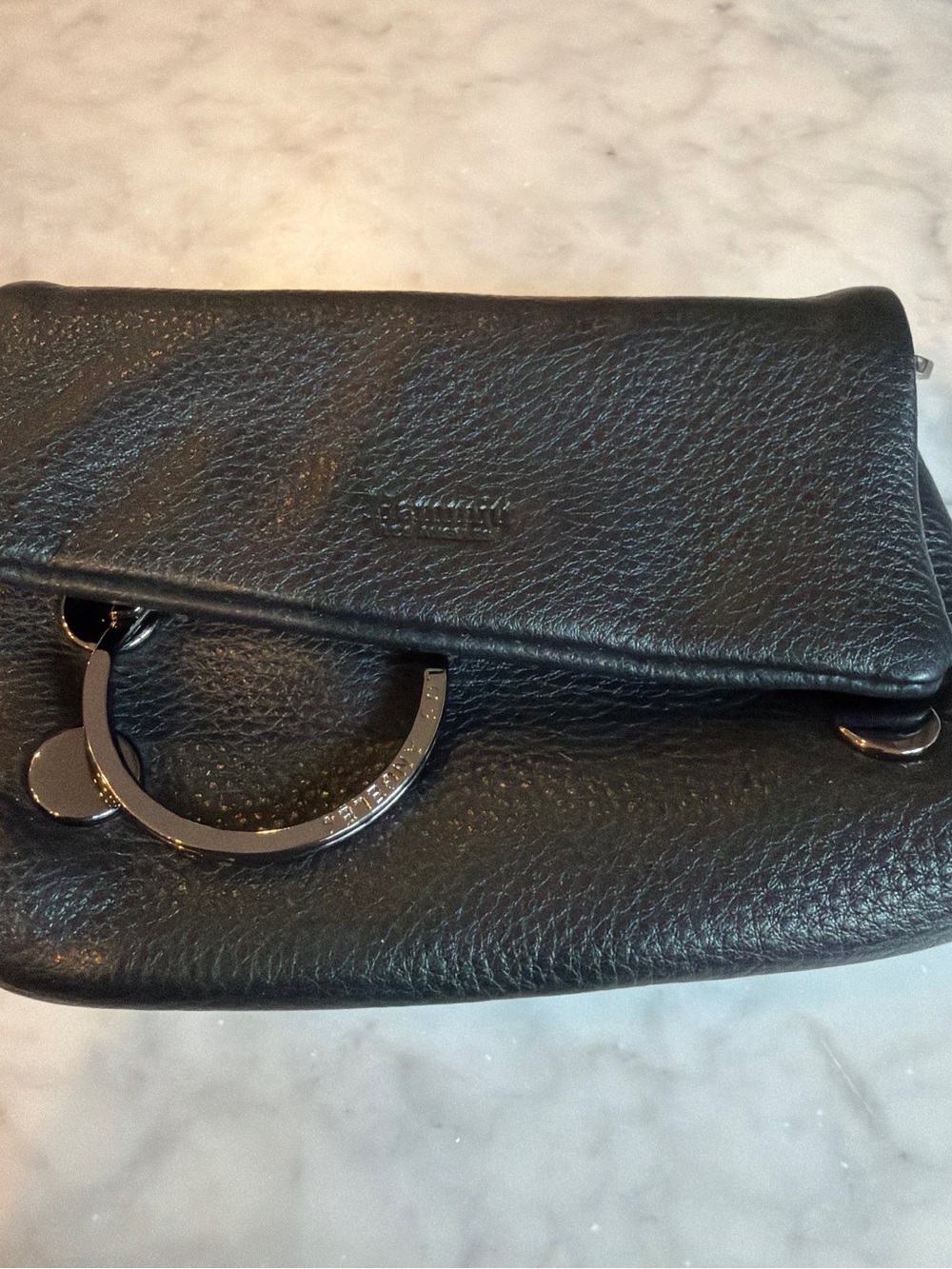Hammitt Small Black Leather bag with Ring Accent and loops for belt.